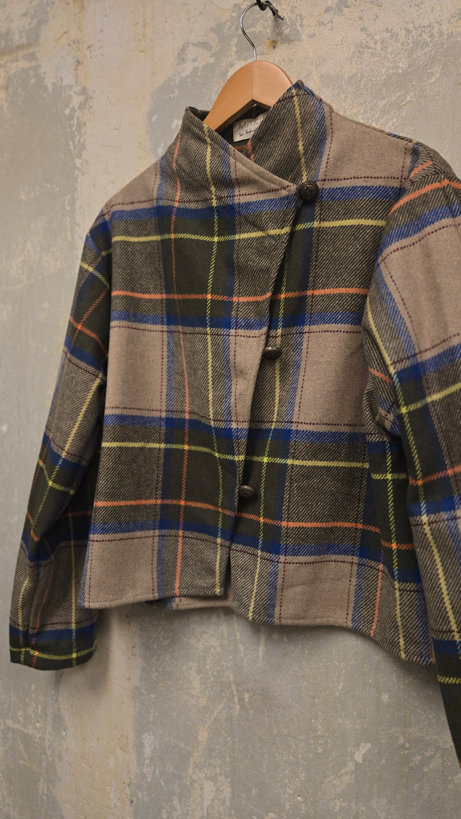 The beige checkered wool jacket